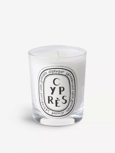 a candle that is sitting on top of a white surface with the words y p r s in it