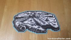 a close up of a piece of art made out of legos on a wooden floor