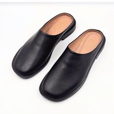 Materials: 100% Genuine Leather Sole: Comfort-contoured Heel: Flat Fit: Snug  Size Chart: For sizing information, please see the size chart included in the picture gallery or use online shoes size converter https://www.gigacalculator.com/converters/shoe-size-converter.php Elevate your style with these sleek Leather Mules for Women: Flat Shoes for Women, Gift for Women  The modern square-toe design adds a touch of sophistication, while the smooth leather construction ensures comfort and quality. Black Closed Toe Slip-ons With Leather Footbed, Black Leather Slip-on Mules, Faux Leather Slip-on Mules With Leather Footbed, Black Leather Open Toe Slip-ons, Black Leather Footbed Slip-ons, Black Slip-on Slippers With Leather Footbed, Classic Black Mules With Rubber Sole, Classic Slip-on Mules With Round Toe, Leather Footbed Mules With Flat Heel For Office