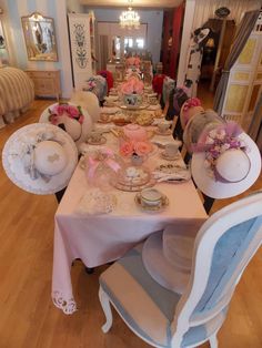 the table is set with pink flowers on it