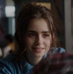 a young woman sitting at a table smiling