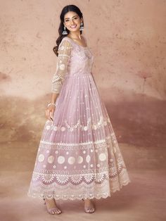 A baby pink net gown adorned with intricate thread embroidery and dazzling mirror work is the epitome of elegance and grace. The soft, delicate hue of baby pink exudes a charming and feminine aura, making it a perfect choice for any festive occasion. The net fabric, known for its lightness and ethereal quality, enhances the gown’s flowing silhouette, ensuring you feel both comfortable and glamorous.
The gown is fully stitched and available in sizes XS and XXL, catering to a wide range of body ty Traditional Dresses For Wedding Guest With Resham Embroidery, Traditional Dresses With Resham Embroidery For Wedding Guest, Traditional Floor-length Gown For Wedding Guest, Festive Lace Dress With Chikankari Embroidery, Embroidered Net Dresses For Eid, Semi-stitched Net Gown For Eid, Eid Organza Gown With Pearl Embroidery, Pink Anarkali Embroidered Dress For Eid, Floor-length Embroidered Anarkali Set In Net