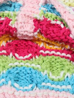 a crocheted blanket with multicolored squares on it's edges and bottom