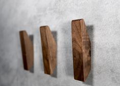 three pieces of wood are hanging on the wall