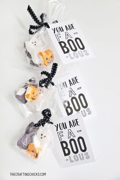 three bags filled with halloween treats sitting on top of a table