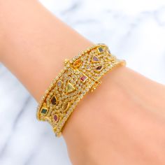 PRODUCT DETAILS Gold Purity(karat): 22k Item Weight(grams): 46.7 Item Finish: Yellow Gold Stone: Polki Diamond Diamond Weight(carats): 10.55ct Accented Stone: Tourmaline Stone Weight: 6.44ct Bangle Size: 2.4 Bangle Opening: 2.25" Openable: Yes, Hinge w/ Screw Gold Diamond Multi-stone Bracelets, Gold Diamond Bracelets With Multi-stones, Elegant Gold Bangle With Multi-stone Details, Elegant Gold Bangle With Multi-stone, Gold Bangle With Gemstone Accents, Gold Cubic Zirconia Bracelet With Gemstone Accents, Yellow Gold Multi-stone Bangle For Wedding, Yellow Gold Multi-stone Wedding Bangle, Luxury Gold Multi-stone Cuff Bracelet