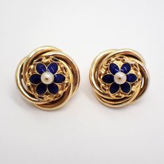 Vintage 16k (.667) yellow gold ornate round form earrings, having dark blue enamel flower centerpiece, accented with Seed Pearl. The backs are 14k (.585) yellow gold (replaced), the earrings were tested to be 16k gold. These majestic earrings are 25 mm in diameter, weighing a total 15.4 grams. EA3502 Elegant Enamel Flower Shaped Jewelry, Formal Enamel Clip-on Earrings, Elegant Enamel Earrings For Anniversary, Gold Round Flower Earrings For Formal Occasions, Gold Flower Earrings For Formal Events, Formal Flower-shaped Clip-on Jewelry, Yellow Gold Flower-shaped Clip-on Earrings For Formal Events, Elegant Enamel Flower Earrings For Wedding, Classic Enamel Earrings For Formal Occasions