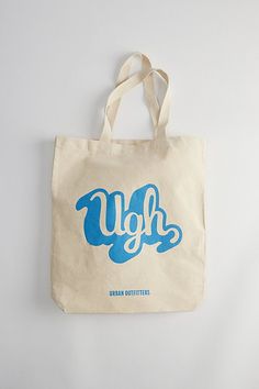 a tote bag with the word ugh printed on it, hanging from a wall