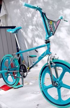 a blue bicycle is parked in the snow