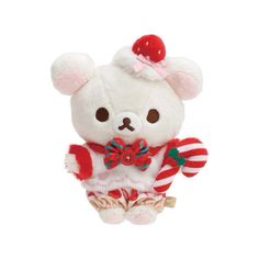 a small white teddy bear wearing a red and white striped outfit with candy canes