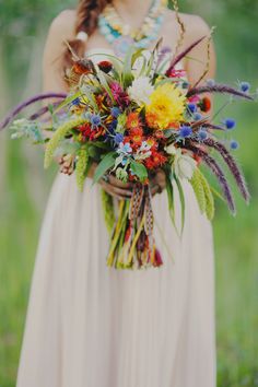 a woman holding a bouquet of flowers in her hands