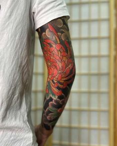 a man with a flower tattoo on his arm