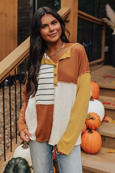 - Fall in love with mixed textures and autumn colors with this trendy top! - Panels of brown material, yellow material, and ivory striped material as well as ivory colored waffle knit material - A v-cut collared neckline with a faux buttoned bodice with wooden accent buttons - Exposed seam accents - Long, loose sleeves - A relaxed silhouette that ends in a straight hemline Colorblock Top, Loose Sleeves, Trendy Top, Color Block Top, Autumn Colors, V Cut, V Cuts, Women Clothing Boutique, Ivory Color