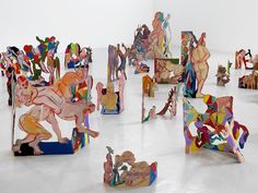 many colorful sculptures are arranged on the floor