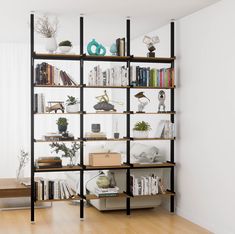 a bookshelf filled with lots of books on top of wooden shelves next to a window