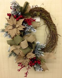 a christmas wreath with poinsettis and greenery