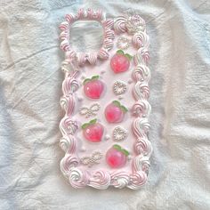 a cell phone case made to look like strawberrys with pearls and jewels on them