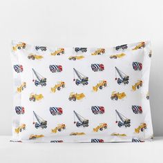 a pillow case with construction trucks on it