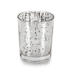 a small glass candle holder with silver speckles on the outside and inside, in front of a white background