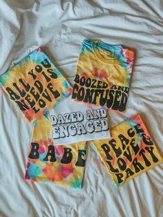 four tie dye t - shirts that say booze and bontued, dazzled and exposed