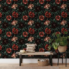 a living room with flowers on the wall and a bench in front of it next to a potted plant