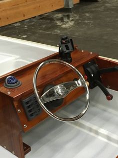 the steering wheel and dashboard of a boat