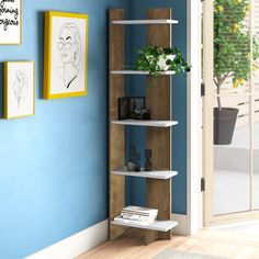 a book shelf in the corner of a room with blue walls and pictures on the wall