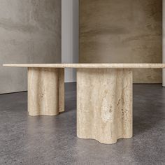 two marble pedestals in the middle of a room with concrete walls and flooring