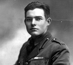 an old black and white photo of a man in uniform