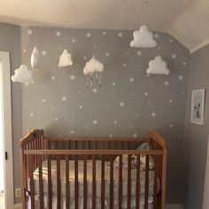 a baby's room with a crib and stars on the wall