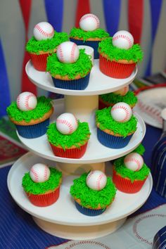 cupcakes with green frosting and baseball decorations on top are arranged in the shape of three tiers