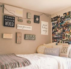 a bed sitting in a bedroom next to a wall filled with pictures and other items