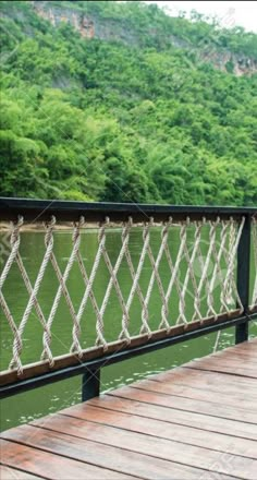 a man standing on a wooden bridge over water