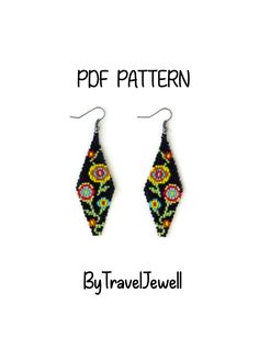 a pair of beaded earrings with black and yellow designs on it, sitting next to the