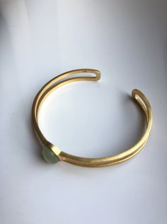 A piece of stylish & modern look gold bangle, which is made with genuine 100% natural real light green Chinese jade bead and 14k gold plated 925 sterling silver bracelet. A great combination of charm and elegance. The minimalistic design is great for your daily wear or special occasions. Perfect as a gift for your loved ones or just as a treat yourself :) Some Highlights of this gold jade bead cuff are: ＊High-quality Material Only 100% natural green jades paired with solid 925 sterling silve Modern Yellow Gold Jade Jewelry, Elegant Gold Jade Bracelets, Elegant Green Bangle Cuff Bracelet, Elegant Adjustable Jade Jewelry, Elegant Yellow Gold Jade Bracelets, Elegant Yellow Gold Jade Bracelet, Gold Jade Bangle, Modern Green Bangle Jewelry, Modern Gold Jade Jewelry