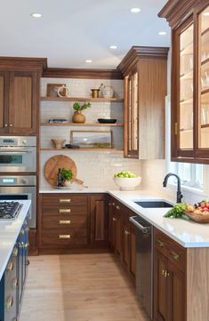 a kitchen filled with lots of wooden cabinets and counter top space next to an oven