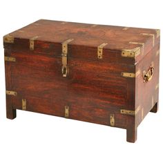 an old wooden trunk with brass hardware on the top and bottom, sitting upright against a white background