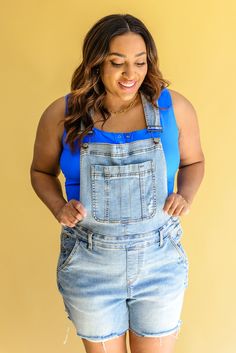 Step into summer style with Devon Distressed Shortalls! These stylish bib front overalls are designed with adjustable straps, mid-rise shorts, a light wash, and distressing. Plus, the cut off hem gives them a modern, edgy look. Are you ready to add some inspiring summer fashion to your wardrobe? Try on Devon Distressed Shortalls today! Judy Blue Adjustable Straps Side Buttons 4-Way Stretch Raw Hem 91.4% Cotton, 7.4% Polyester, 1.2% Spandex True to Size S: Waist 29" Hips 39" Inseam 4" Torso 27"-3 Denim Overalls Shorts, Mid Rise Shorts, Judy Blue Jeans, Edgy Look, Spice Girls, Swim Bottoms, Overall Shorts, Favorite Jeans, Try On