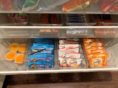 an open refrigerator filled with lots of different types of food and snacks in plastic containers