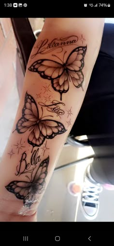 a woman's arm with butterfly tattoos on it