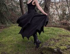 "The Batwing Wrap Skirt features a full hem and a generous overlap for greater practicality of movement (yes, you can climb trees). The pleated batwing edging adds both visual interest and a weighted luxury of movement to the garment. The Batwing Skirt is fully adjustable with waist ties. Also features a a stylized patch pocket suitable for small arcane treasures. Made from heavyweight linen. Note that this listing is for Lengths 35\"-44\". This is measured from the top of the waistband to the points of the hem. If you would like a maxi length skirt I would recommend taking a measurement from your natural waist (or wherever you wear your skirts) to to ground and then to reduce that number by 2-3\" so that the skirt does not drag on the ground. If you have any questions about how to measure Bat Top, Bat Wing Jacket, Bat Shawl, Bat Skirt, Gothic Flowy Black Maxi Skirt, Cottagecore Skirt, Streetwear Skirt, Retro Skirt, Classic Skirts