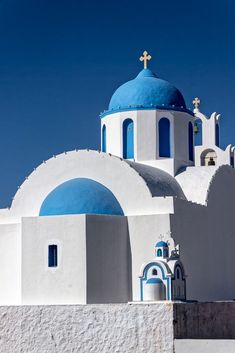 a white and blue church with two bell towers