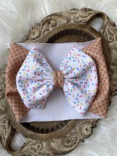 This beautiful ice cream cone baby headwrap is made using soft textured stretchy polyester fabric, in a fun ice cream print pattern. Headwrap has brown waffle cone pattern, and bow has white background with colorful sprinkle pattern. Bow is hand tied into a cute bow shape then hand sewn for durability.  Bow is securely sewn to the headband (so there's no bulky knot) and is 5 inches in width (newborn is 4-inches in width). Fabric is soft and will stretch 1-2 inches, so it will accommodate growing babies. Headwrap is 5 inches wide (newborn is 4-inches wide). See chart in listing for specific sizes available. Check out the headwrap collection here:  As always, if you would like a different size headband or bow, feel free to message me so I can set up a custom listing. I will do all I can to a Beautiful Ice Cream, Diy Baby Bows, Cone Pattern, Fun Ice Cream, Big Bow Headband, Ice Cream Print, Waffle Cone, Baby Head Wrap, Stretchy Headbands