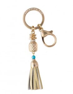 a key chain with a pineapple and tassell on it's end