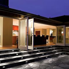 an outdoor living area with steps lit up at night