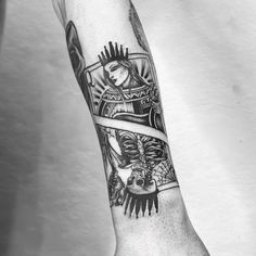 a black and white photo of a person's arm with tattoos on it