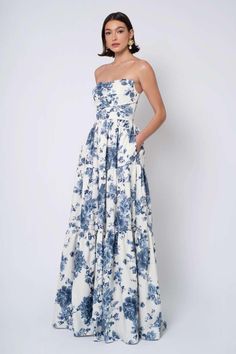 Style Sutton: features a straight neckline with detachable puff sleeves and tiered skirt in floral print By Jenny Yoo Ardmore, PA & Morristown, NJ Blue And White Floral Wedding Dress, Blue Fall Bridesmaid Dresses, Blue And White Floral Bridesmaid Dresses, Garden Formal Dress, Protocol Dresses, Mob Gowns, Wedding Rehearsal Outfit, Detachable Puff Sleeves, Jenny Yoo Bridal