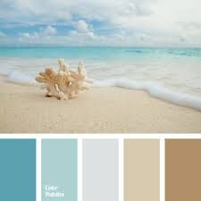 a beach scene with the ocean and sky in shades of blue, beige, and white