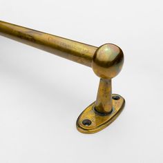 an antique brass door handle on a white background