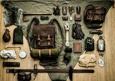 an assortment of items are laid out on a table with one bag and the other purse